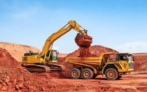 Mass excavation with excavator and hauler